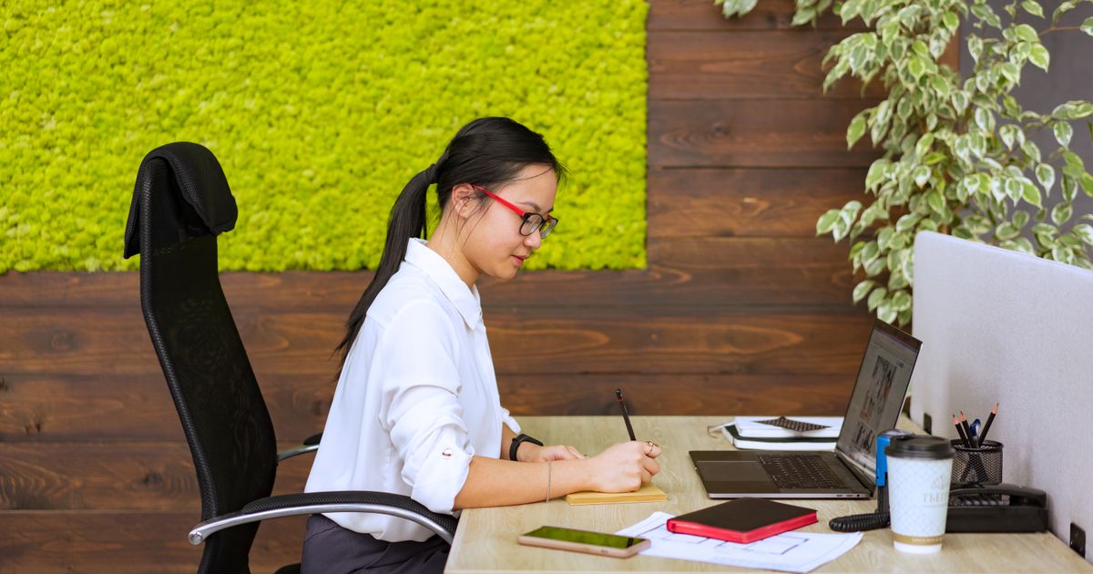 Balancing Passion: Employee implementing eco-friendly practices in a corporate setting.