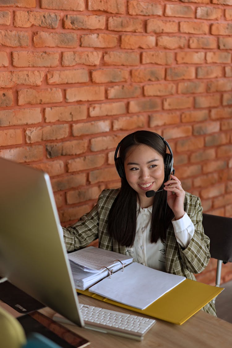 A Woman Using Headphones While Working