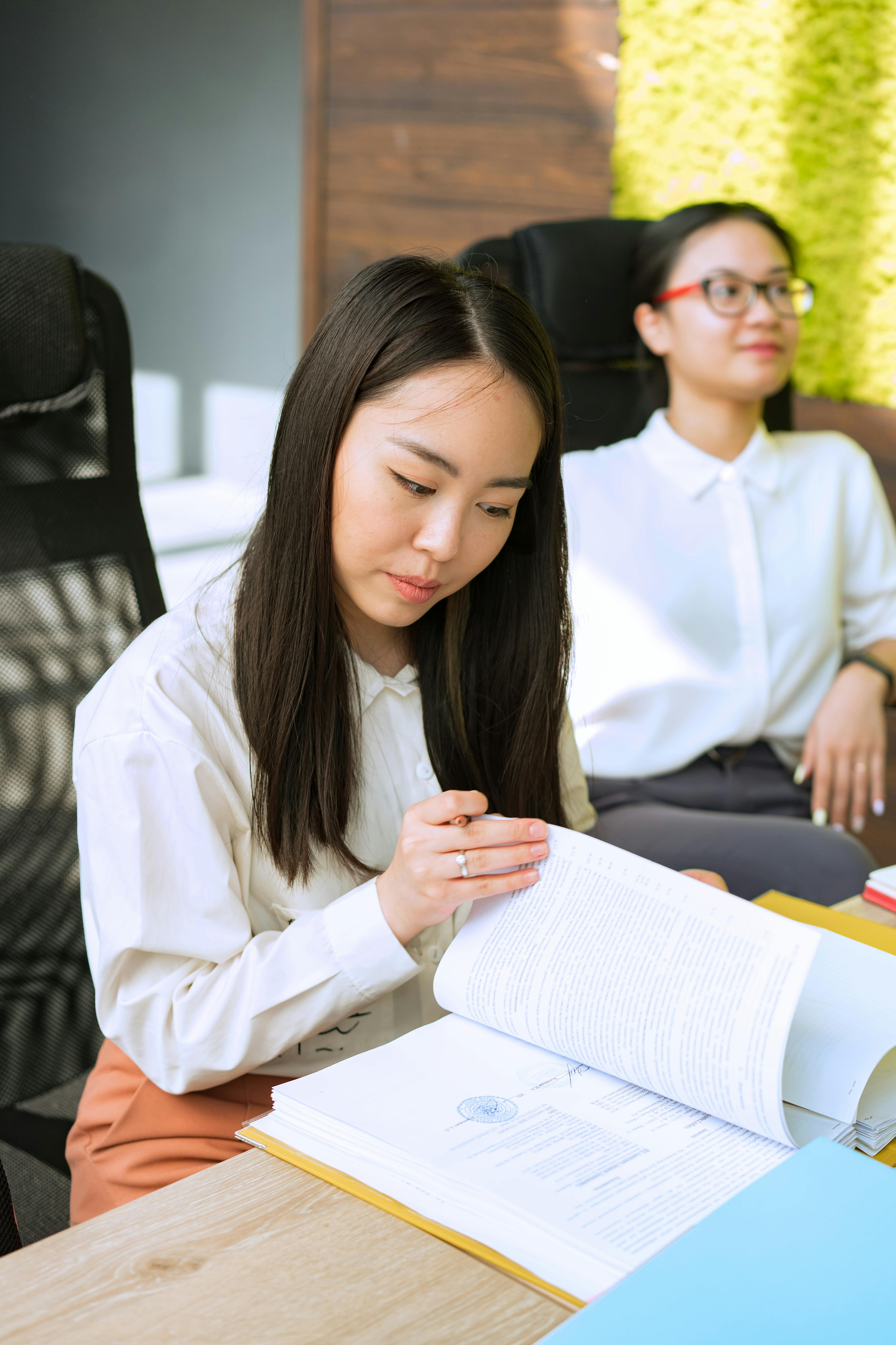 Audience members reading concert programs before a performance