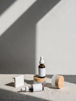 Stylish layout of skincare products with dropper bottles and jars against a soft backdrop.