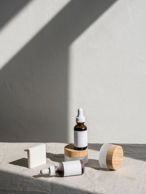 Free Stylish layout of skincare products with dropper bottles and jars against a soft backdrop. Stock Photo