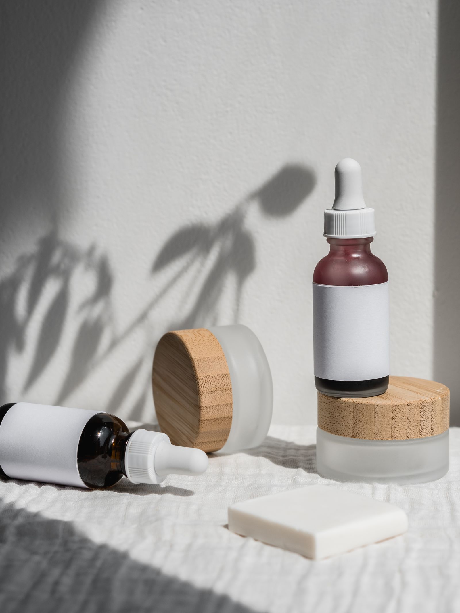 Skincare jars and dropper bottles on a shelf