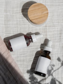 Flat lay of natural cosmetic bottles and jar with shadows on a fabric background, perfect for branding.