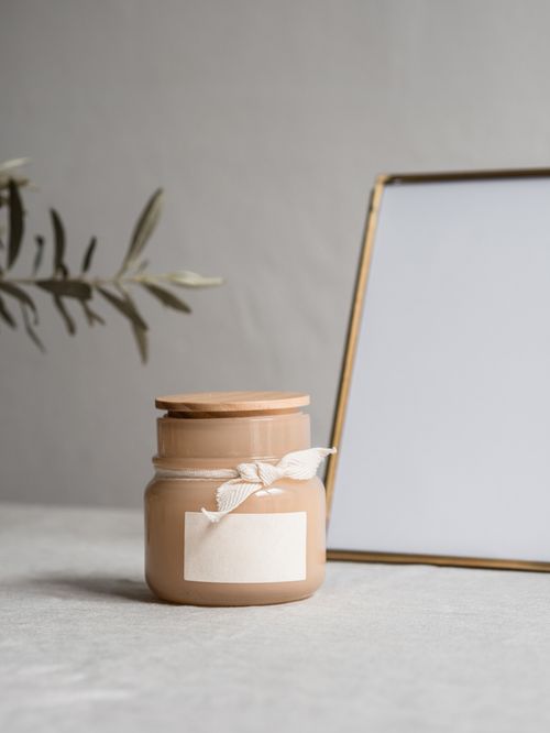 Free Minimalist setup featuring a stylish jar and blank photo frame. Perfect for mockups. Stock Photo