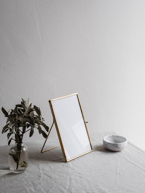 Free White Photo Frame on a White Fabric Stock Photo