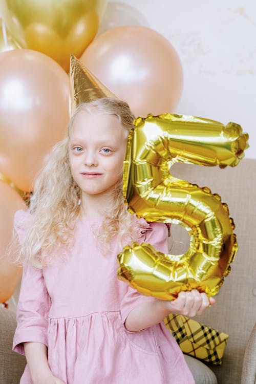 A Young Girl Celebrating her 5th Birthday