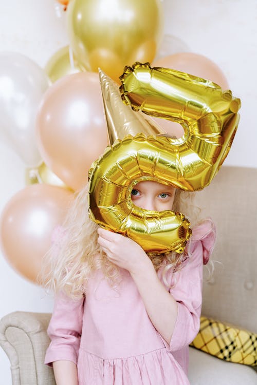 Free Girl Holding Balloon Near Her Face Stock Photo