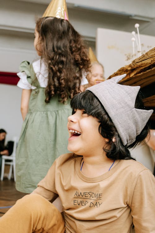 A Boy Smiling Sitting on the Floor