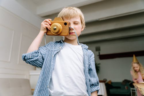 Playful Boy using a Toy Camera 