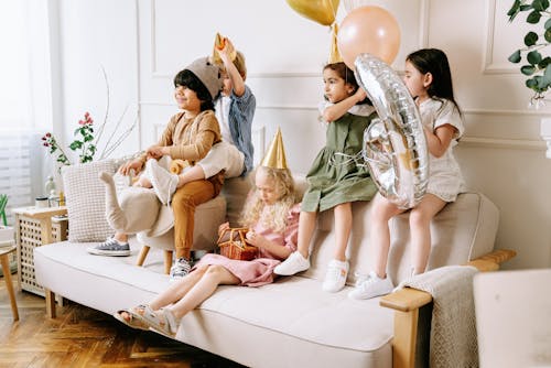 Free A Children Sitting Together on the Sofa Stock Photo