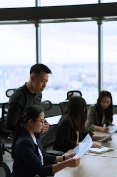 Business team collaborating in a modern office setting with natural light.