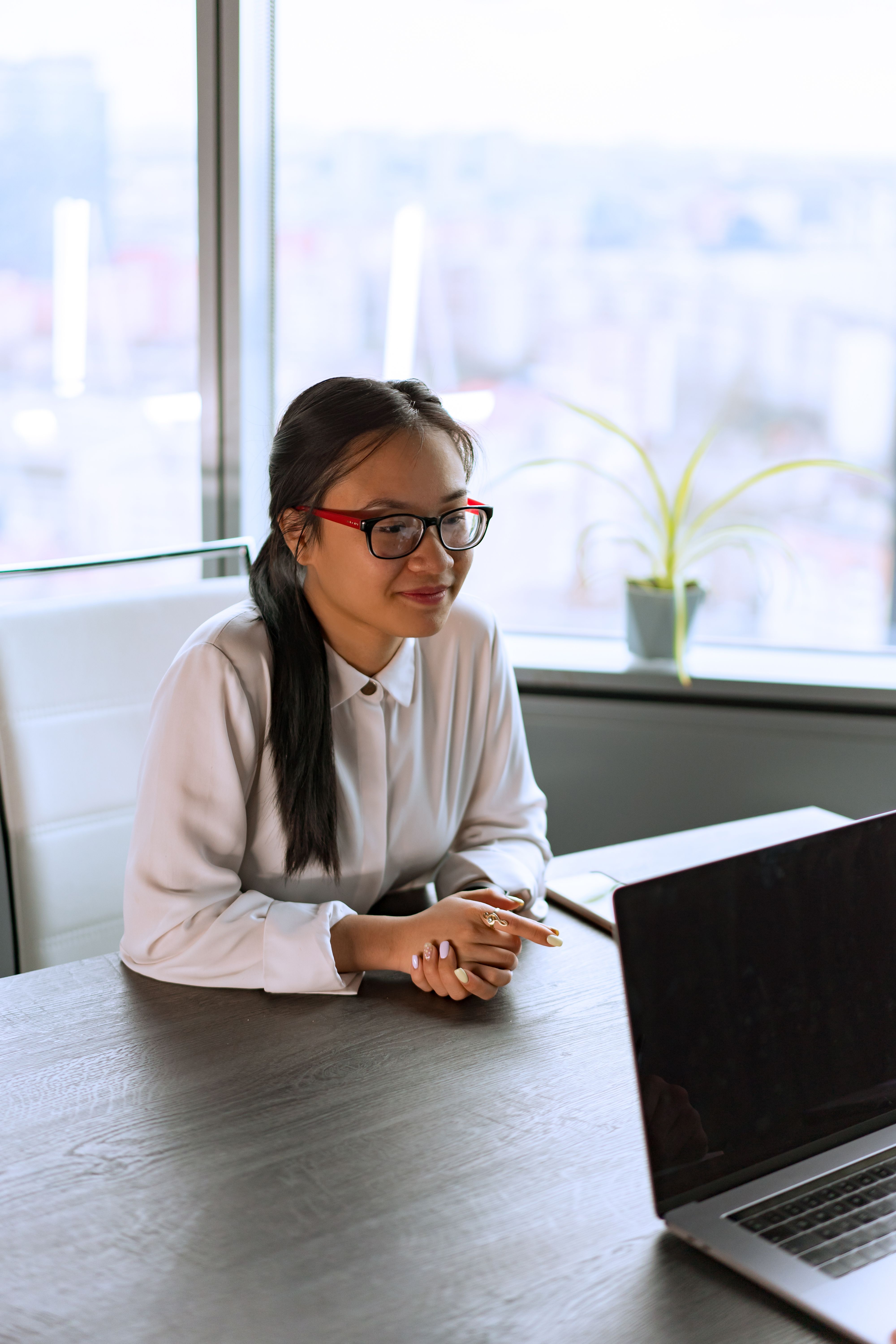 A Woman in White Long Sleeves Leaning on a Table · Free Stock Photo