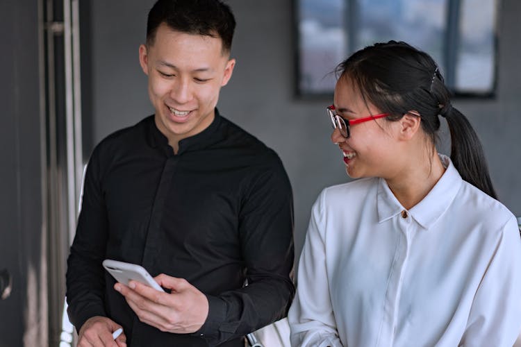 Young People Looking At A Smartphone Screen 