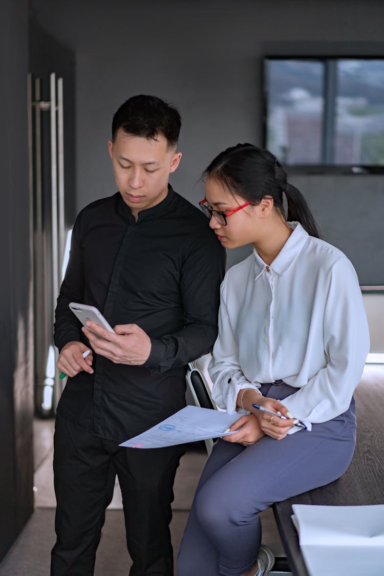 A Male And Female Colleagues Discussing A Plan