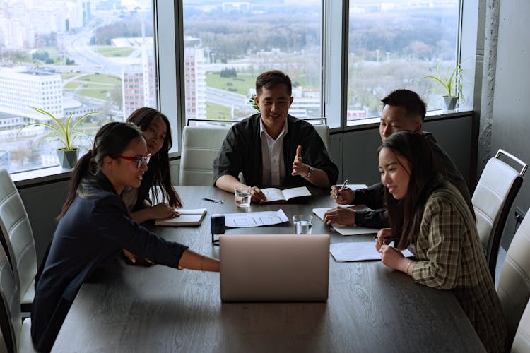 A Group Of People In A Meeting Room