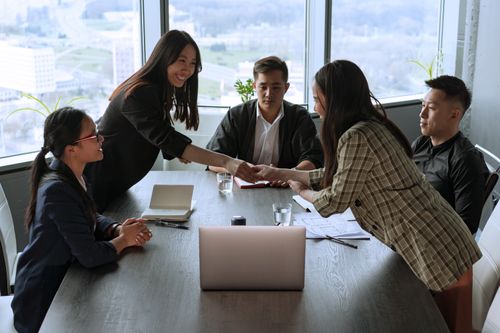 Free A diverse group of professionals collaborating in an office meeting, fostering teamwork and innovation. Stock Photo