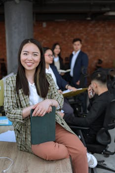 A group of diverse young professionals collaborating in a modern office setting, showcasing teamwork and productivity.