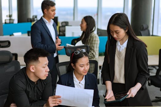 A diverse group of professionals brainstorming ideas together in a modern office setting.