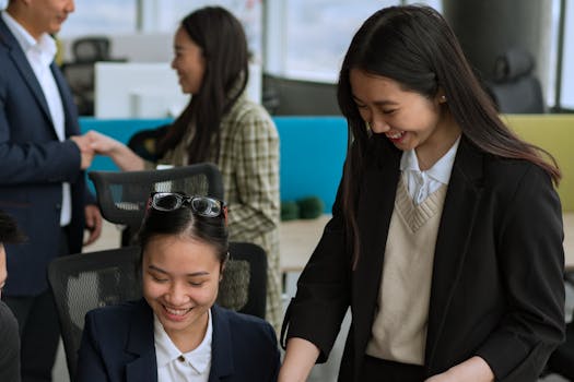 Asian professionals collaborating in a bright modern office setting.