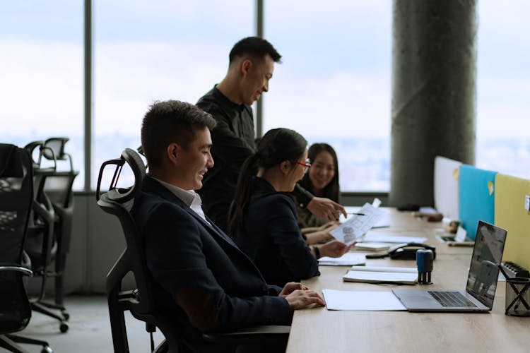 Group Of Men And Women Smiling At Work