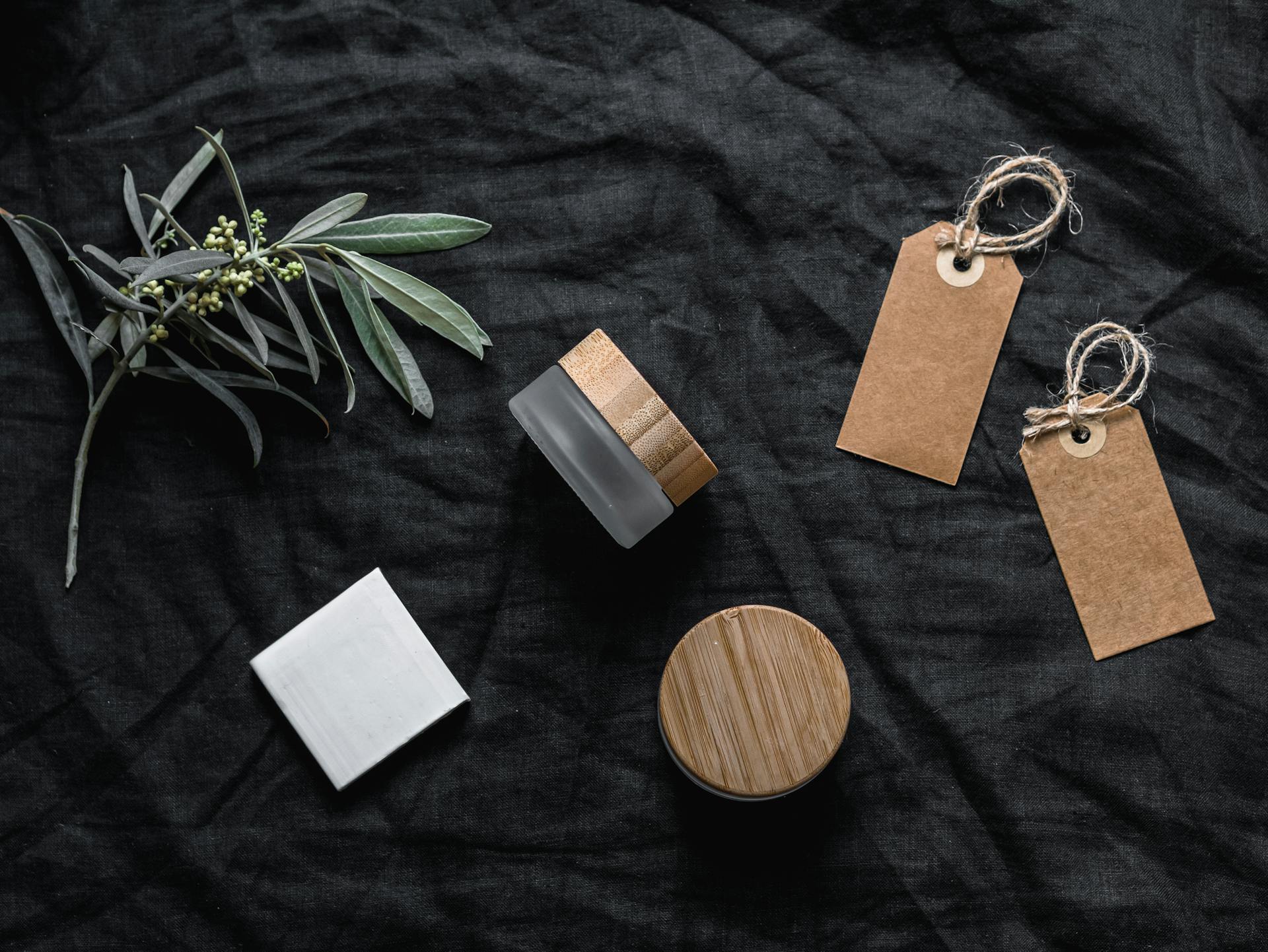Glass Containers With Wooden Lid Beside Tags and White Paper