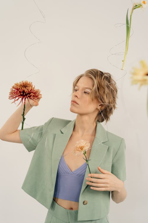 Woman with Short Hair Touching a Hanging Flower