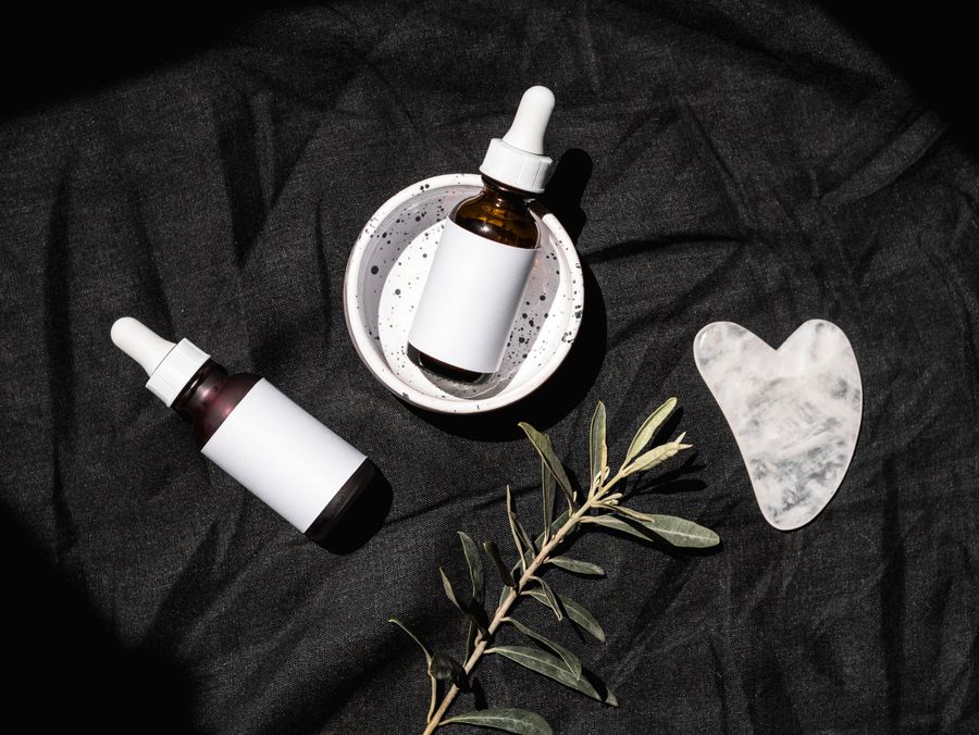 Unlabeled personal care and hygiene bottles arranged in a flat lay
