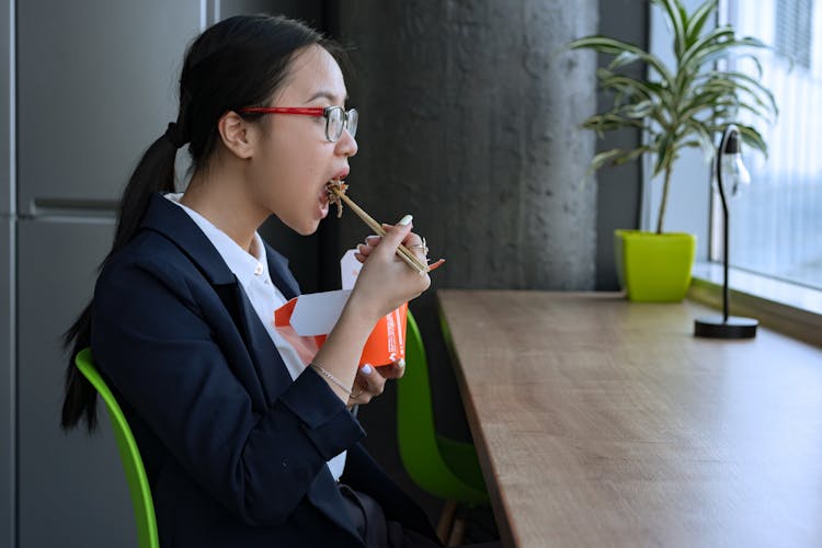 Woman Eating Using Chopsticks