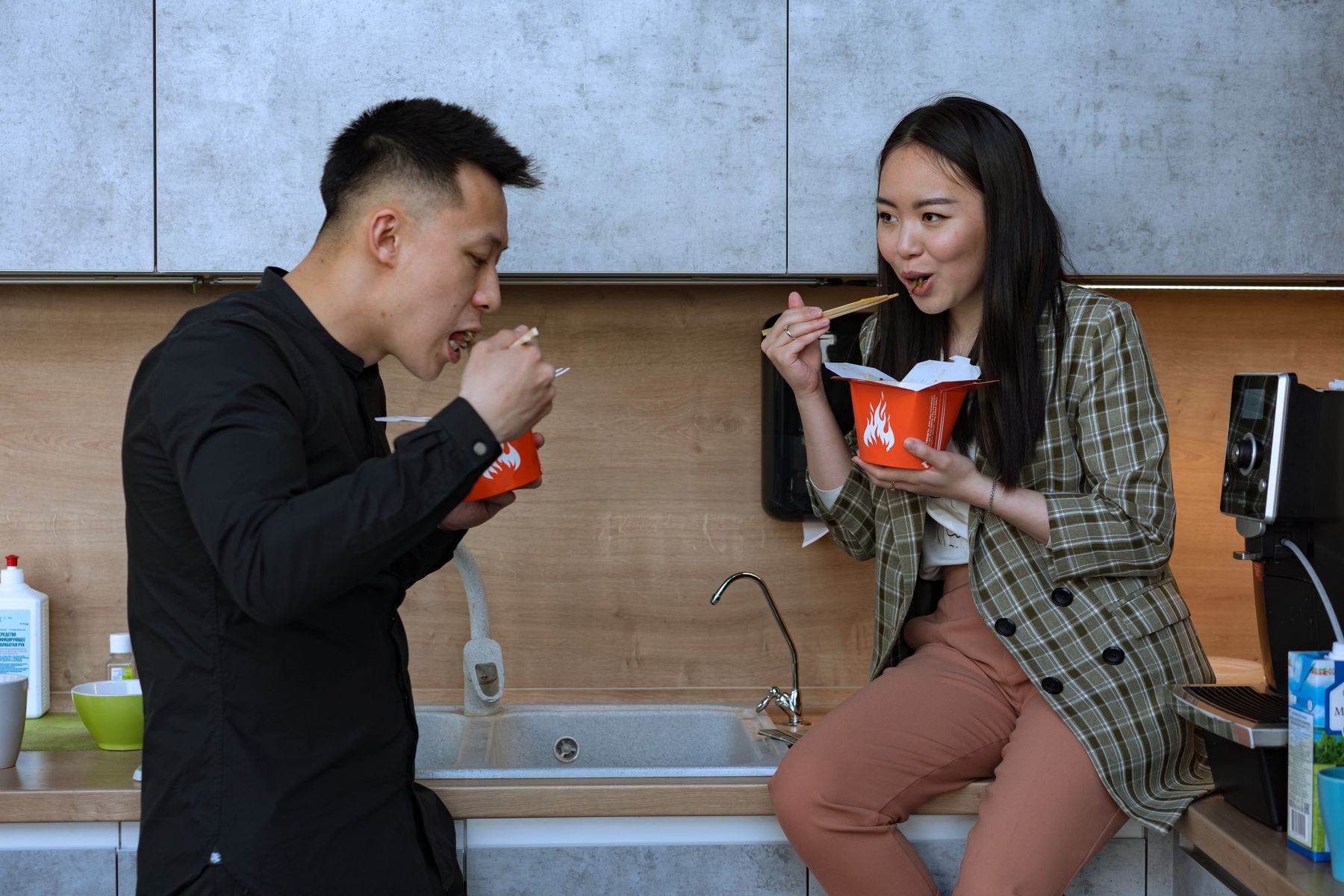 Coworkers sharing lunch in the office kitchen