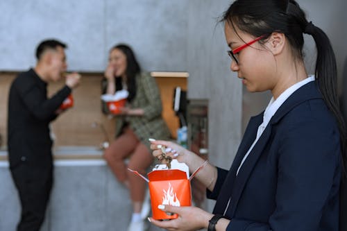 Woman Wearing Blazer Eating with Chopsticks
