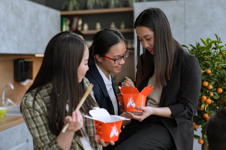 Women Eating Using Chopsticks