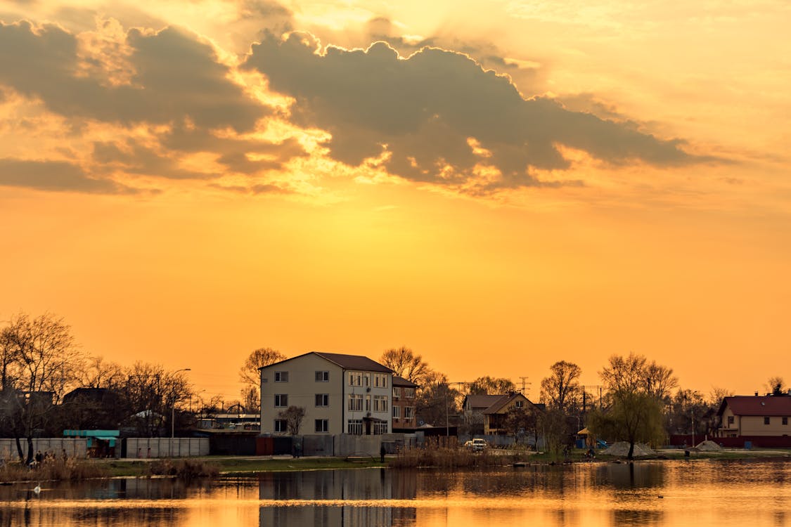 Houses by River at Golden Sunset