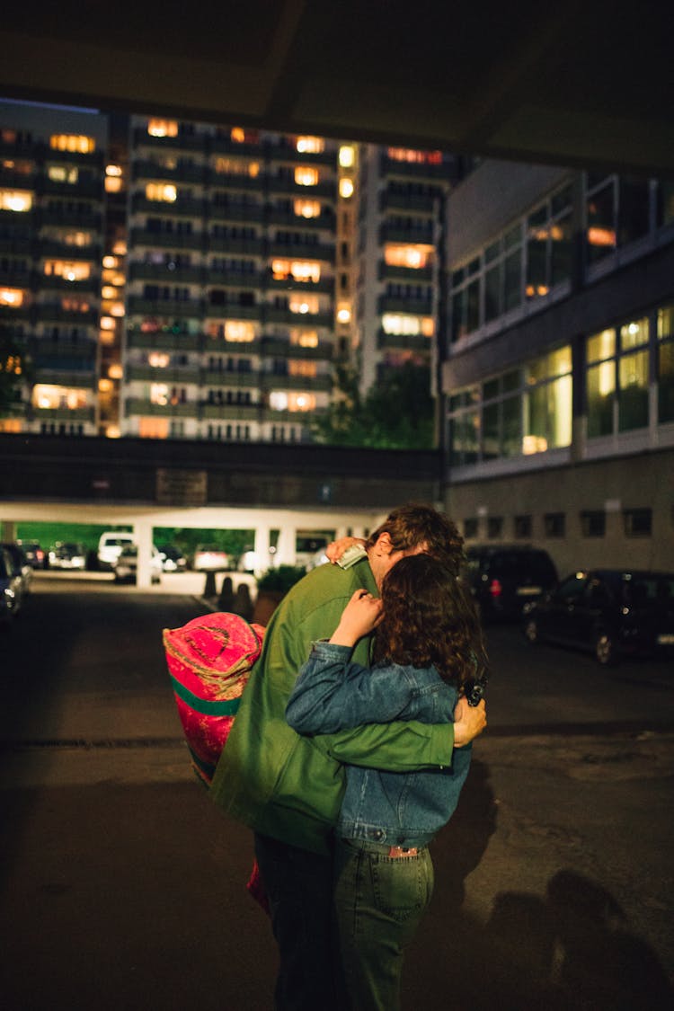 Couple Kissing Near Concrete Building