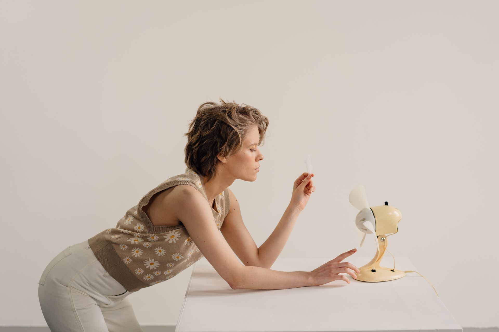 A Woman Looking the Desk Fan