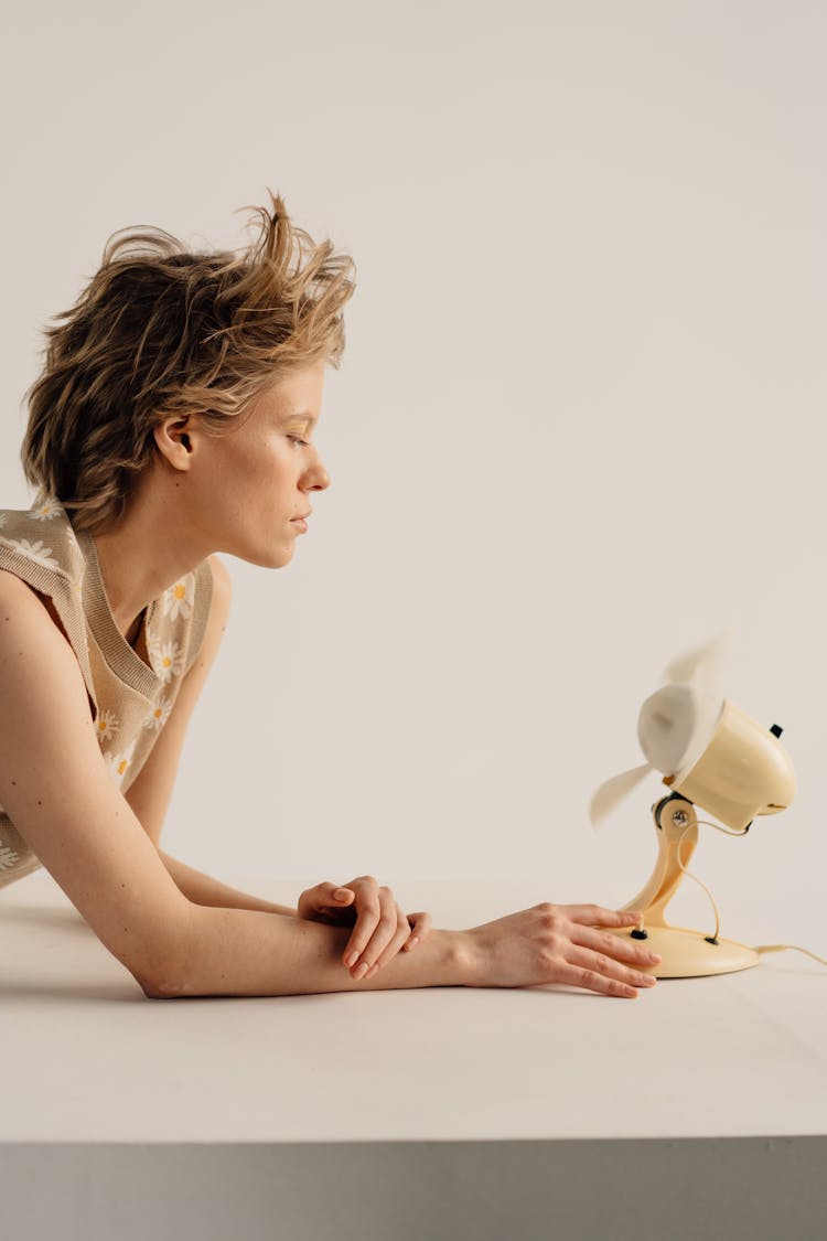 Woman Holding A Small Electric Fan