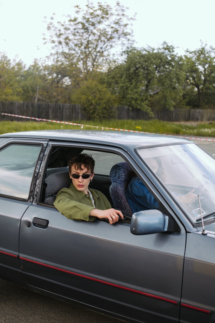 Man Wearing Black Sunglasses Holding A Gun