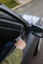 A Person holding Gun in the Car