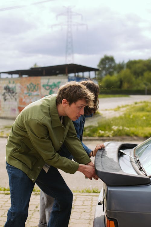 A Man hiding Behind the Car