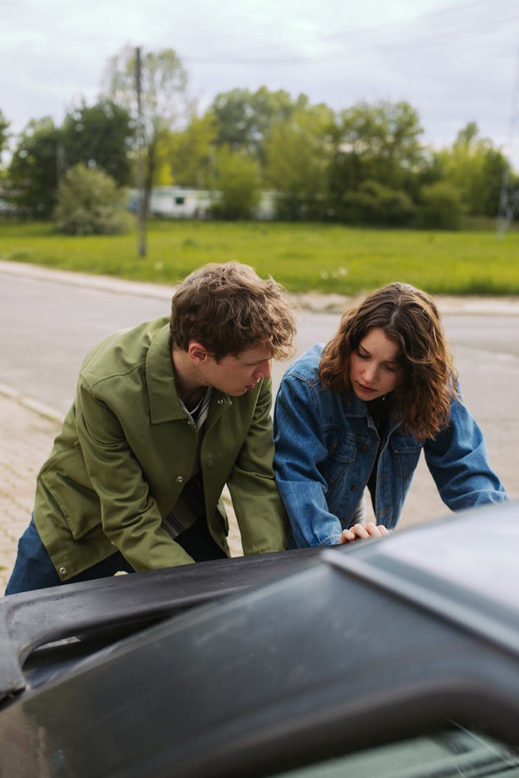 Man And Woman Pushing  A Car