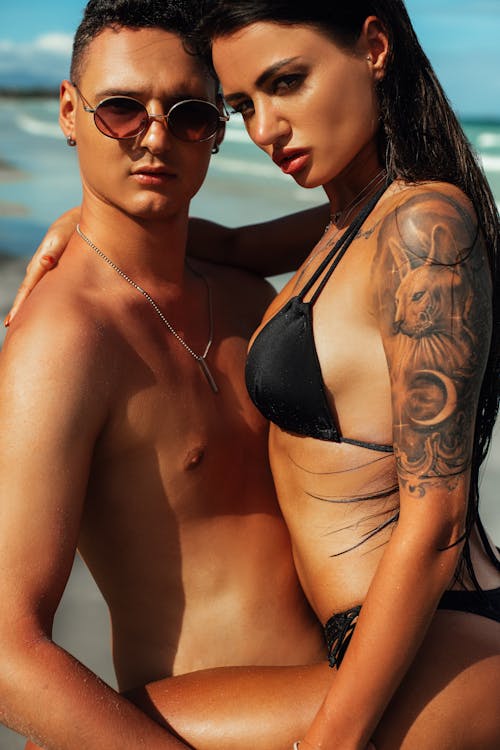 Shirtless Man and a Woman in a Black Bikini