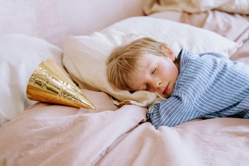 Free Boy Sleeping on Bed Stock Photo