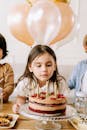 Pretty Girl Looking at a Cake