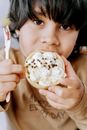 Boy Holding a Cookie and a Spoon