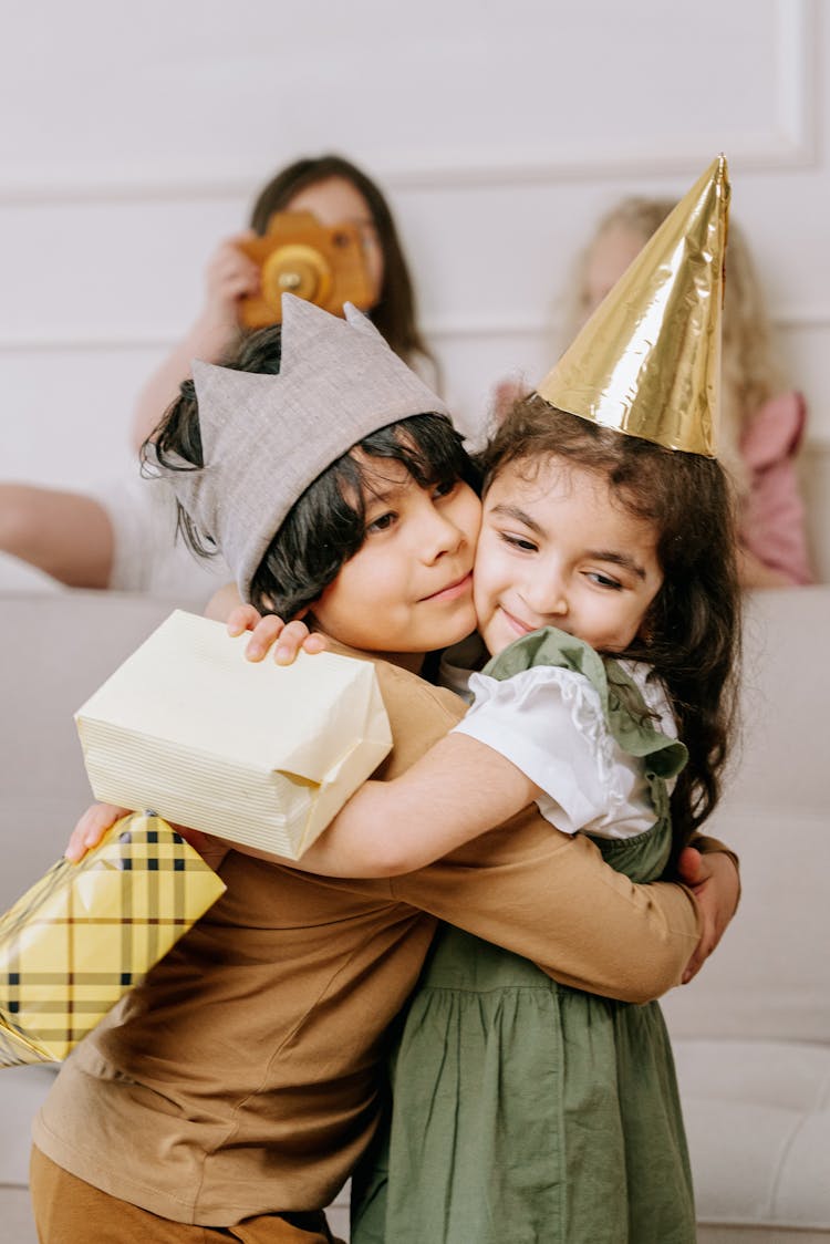 Kids Hugging In A Kids Party