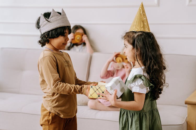 
A Boy Giving A Gift To A Girl