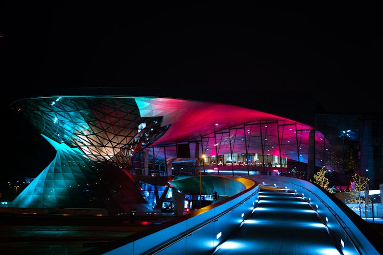 Illuminated Driveway Into A Modern Building At Night