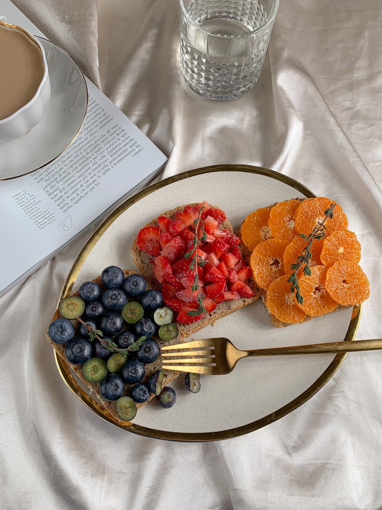 Sliced Fruits On Bread On A Ceramic Plate