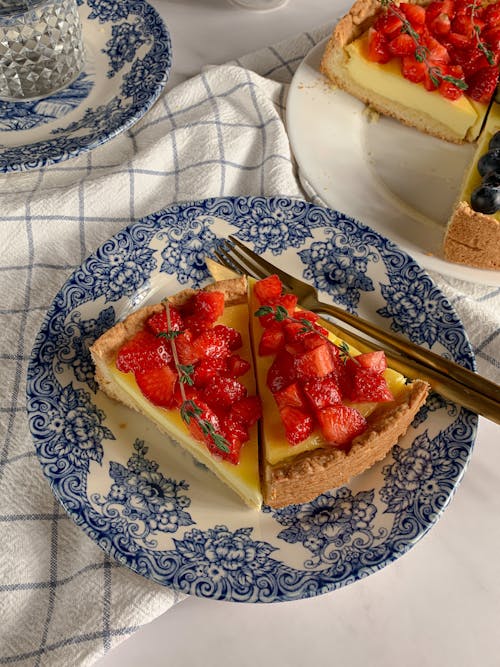 A Sliced Cake with Strawberries on a Plate