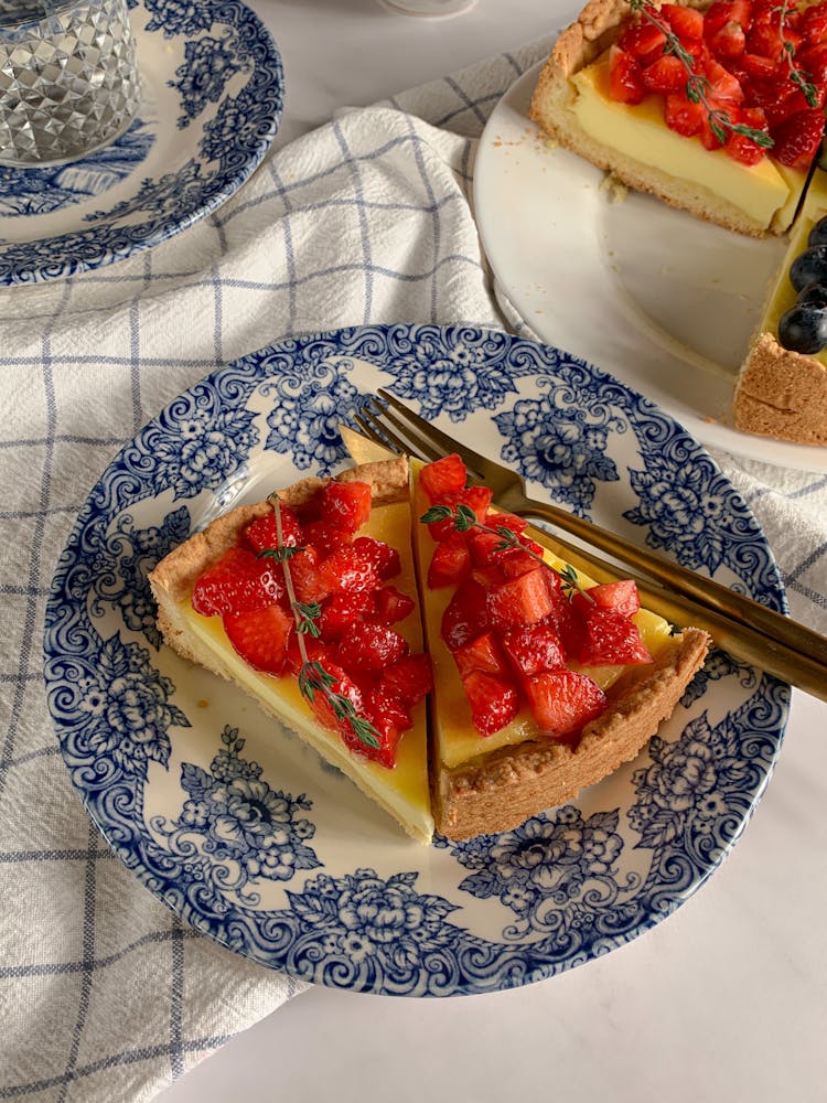 A Sliced Cake With Strawberries On A Plate