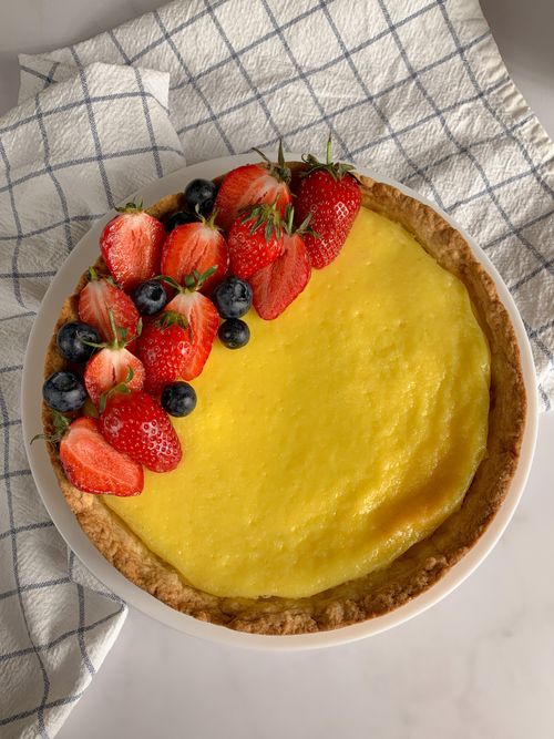 Free A vibrant fruit tart with fresh strawberries and blueberries on a baked crust. Stock Photo